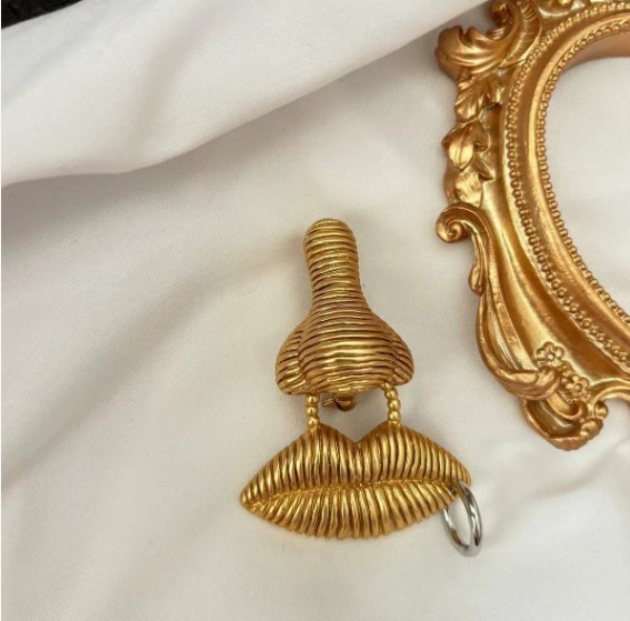 Schiaparelli surreal facial features series nose mouth gold tone texture brooch