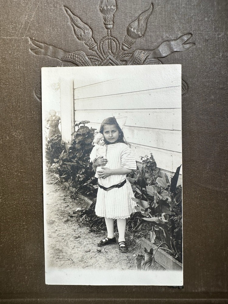 Antique 1910s girl child with doll sepia RPPC photo postcard