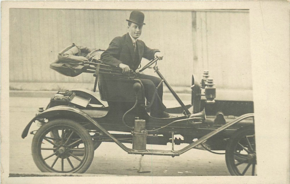 c1910 Well dressed man in early automobile RPPC Postcard 25-2586