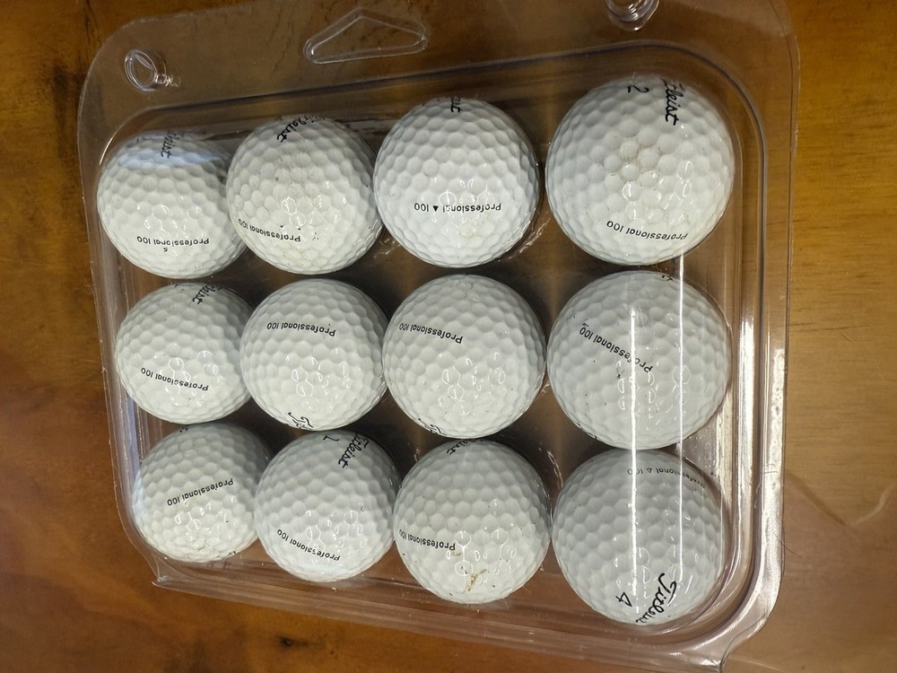 One dozen titleless Professional 100 golf balls