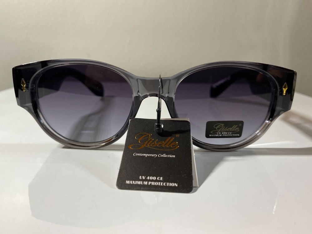 Women's cat eye style sunglasses with gray color frame and purple tinted lenses