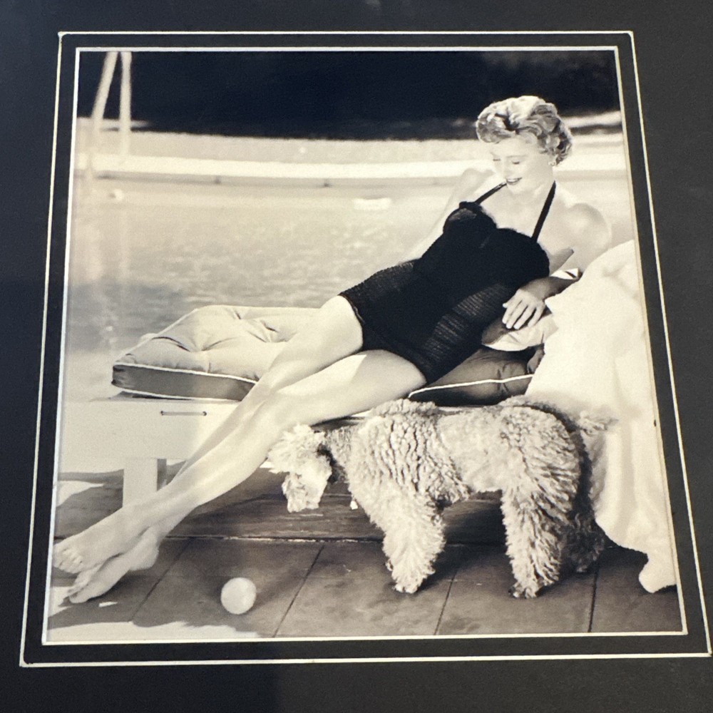 Barbara Stanwyck lounging poolside with her dog in classic 7x7 photo