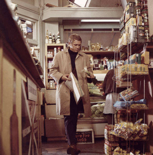 Steve McQueen picking up a newspaper supplies at a store in Peter - Old Photo