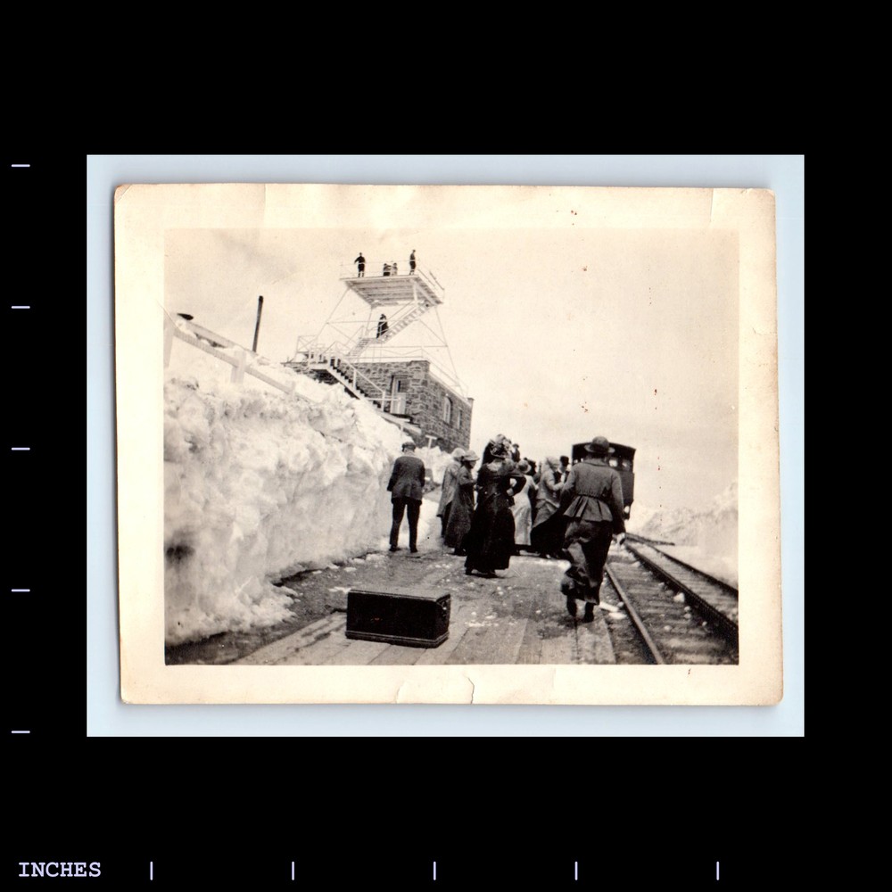 Old Vintage Photo of Men and Women at a Snowy Train Station Featuring Strong Box Lockers and Pikes Peak