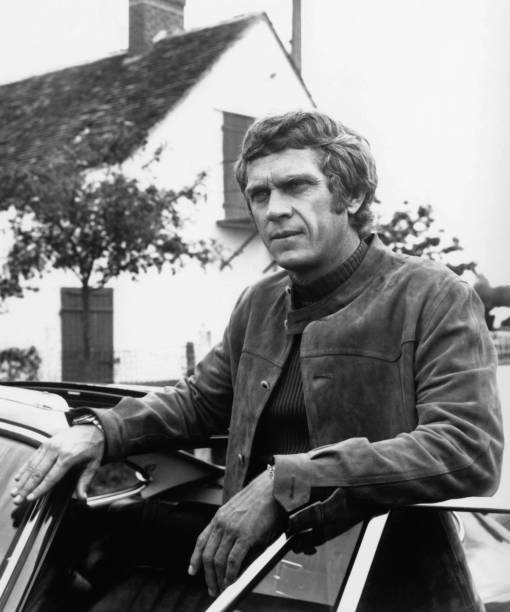 Steve McQueen portrait wearing suede jacket posing by sports car f- Old Photo
