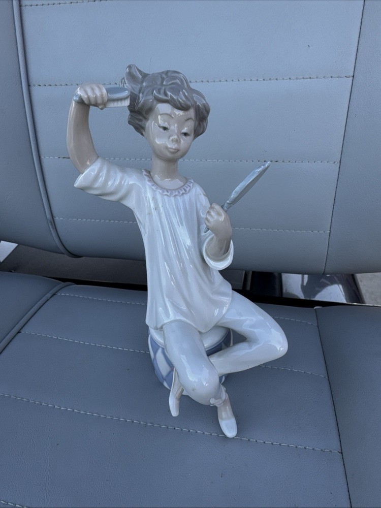 Lladro porcelain figurine of girl holding mirror and hairbrush