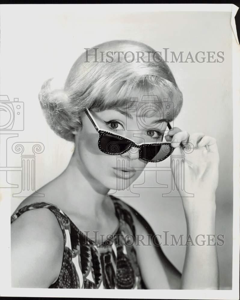 1964 Press Photo A young lady models a pair of sunglasses - lra44401