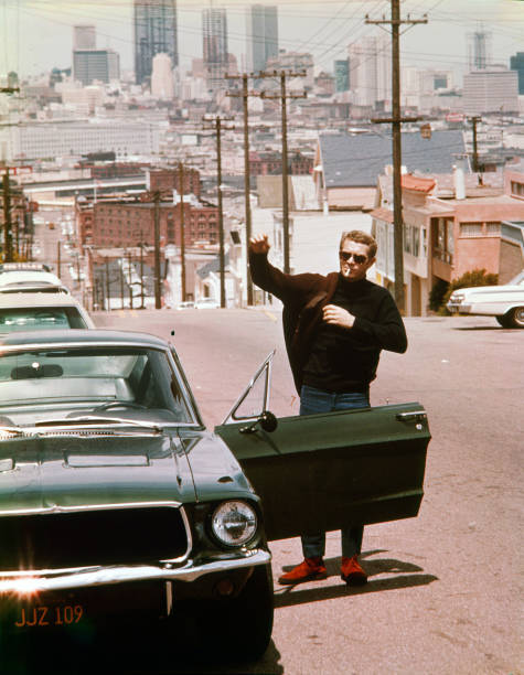 Steve McQueen standing by a Ford Mustang in the 1968 thriller Bull- Old Photo