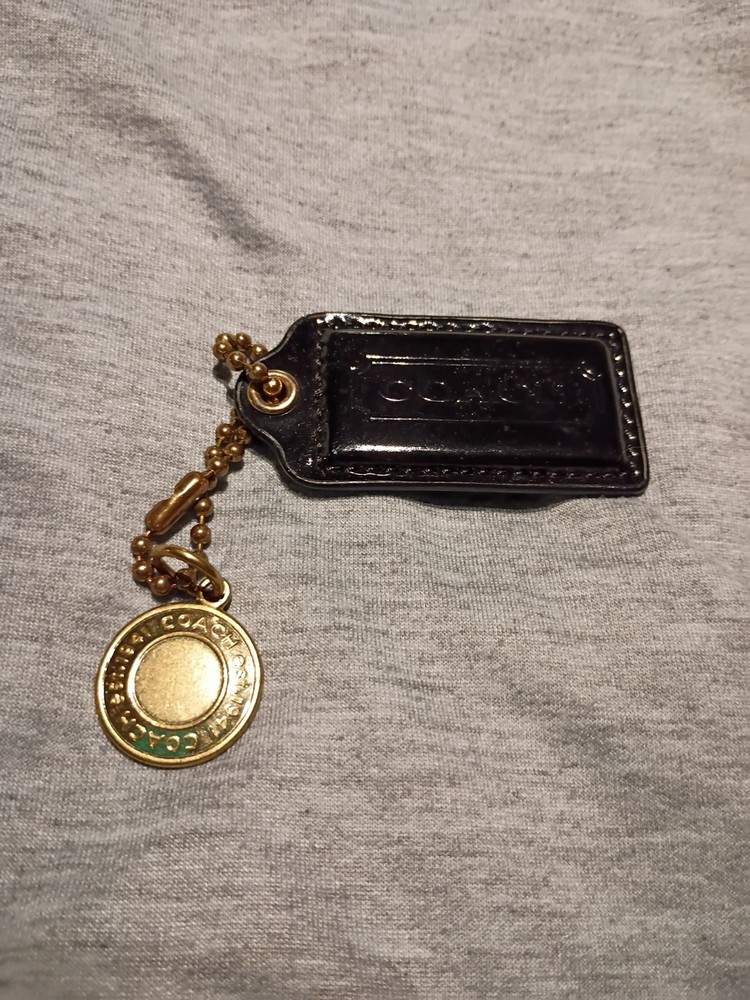 Coach Hang Tag W/ Chain And Charm.  Black Tag With Gold Colored Chain And Charm