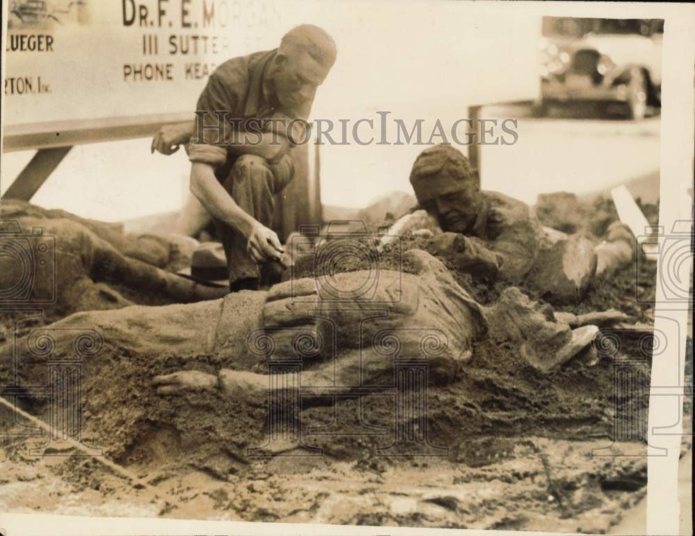 1930s Sculptor Tillman Beck crafting sand sculpture in California