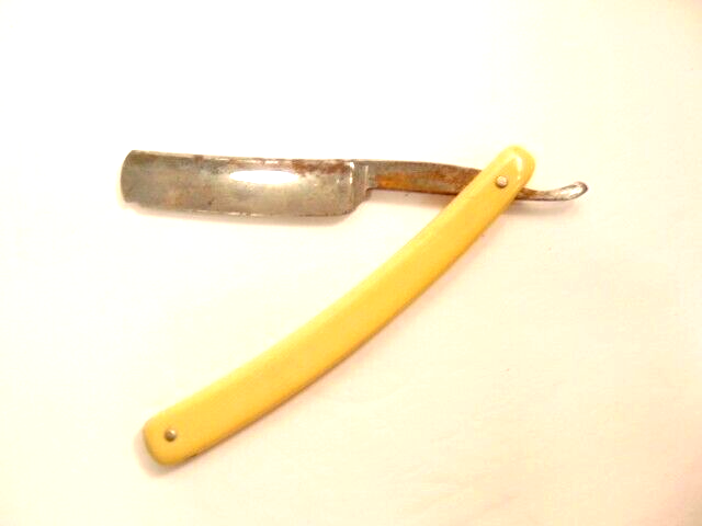 vintage Worcester Razor Co. straight razor with yellowish plastic handle