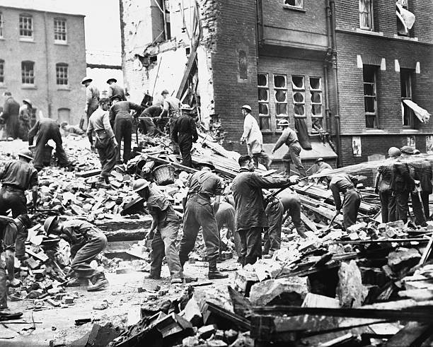Rescue workers pick through the debris of a hospital bombed during- Old Photo