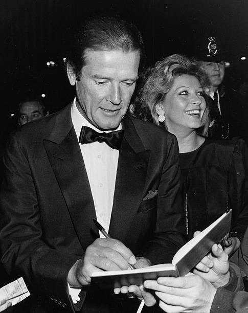Roger Moore with his wife Luisa signing autographs outside Royal A- Old Photo