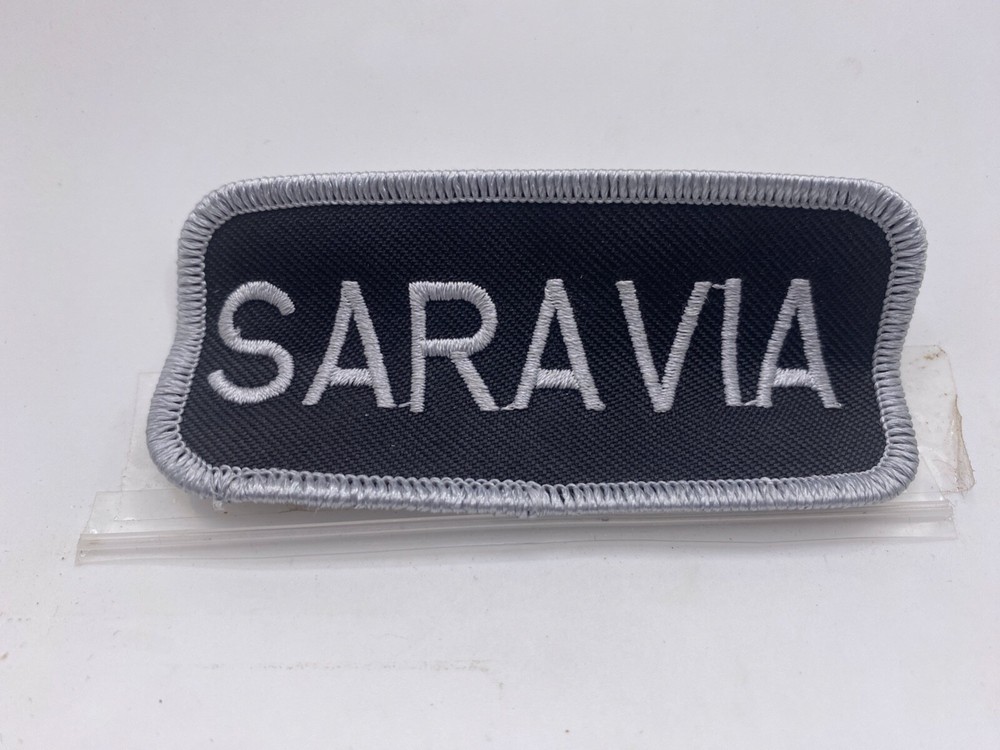 SARAVIA  USED EMBROIDERED VINTAGE SEW ON NAME PATCH TAGS WHITE ON BLACK