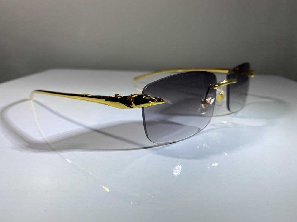 Men's rimless rectangular gold wire frame sunglasses with smoke gray lenses