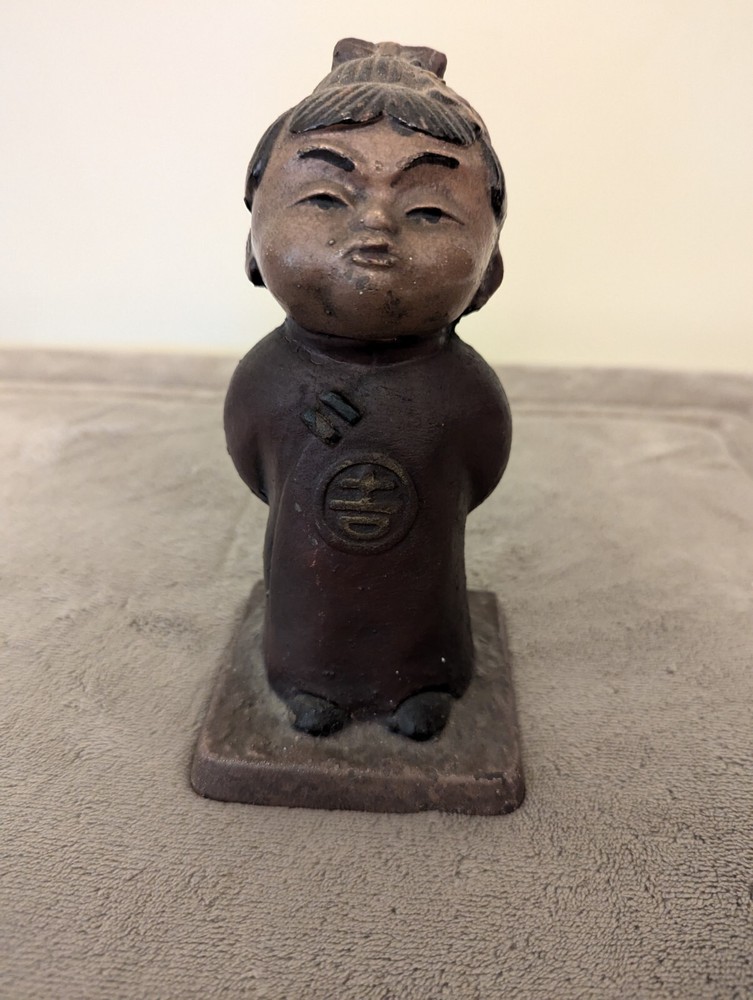 Cast Iron Chinese child statue painted in black, brown and red colors old & used