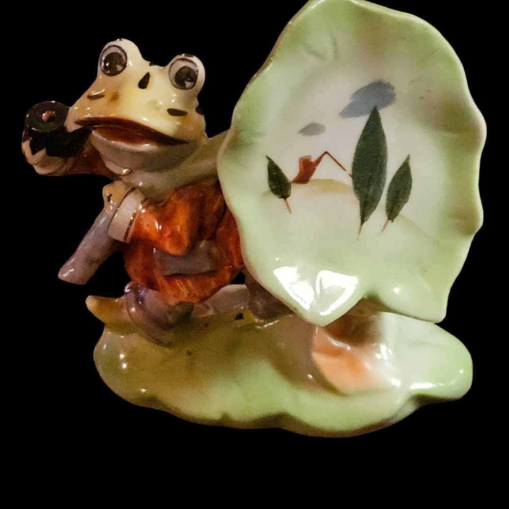frog smoking pipe And Carrying A Painted Leaf