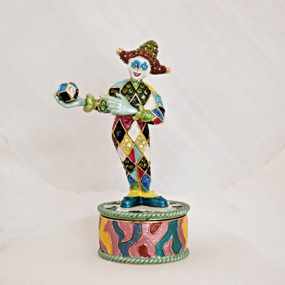 Colorful Happy Harlequin Clown Holding Pink and Green Ball
