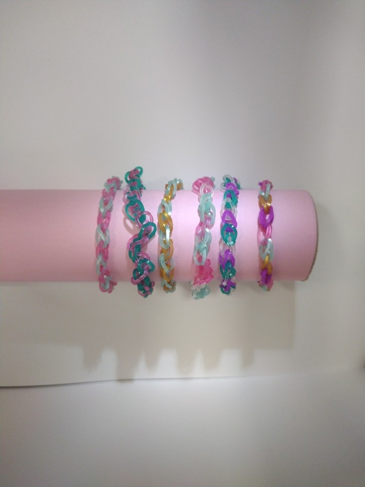 A Set Of 5 Loom Bracelets That Are All A Metallic Beachy And Summer Vibe.