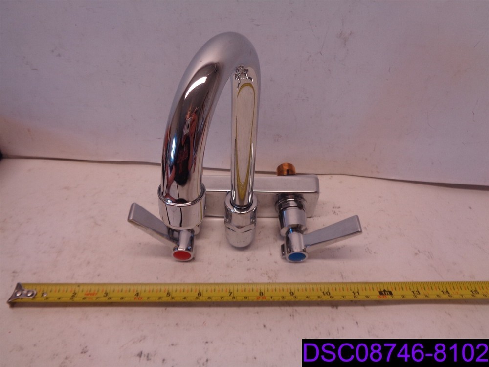 Chrome 2-Handled Faucet with Swivel Head and Dent on Base