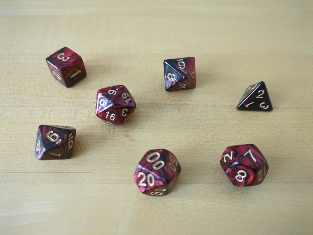 set of 7 dice, black + red-shimmer swirl with gold numbers