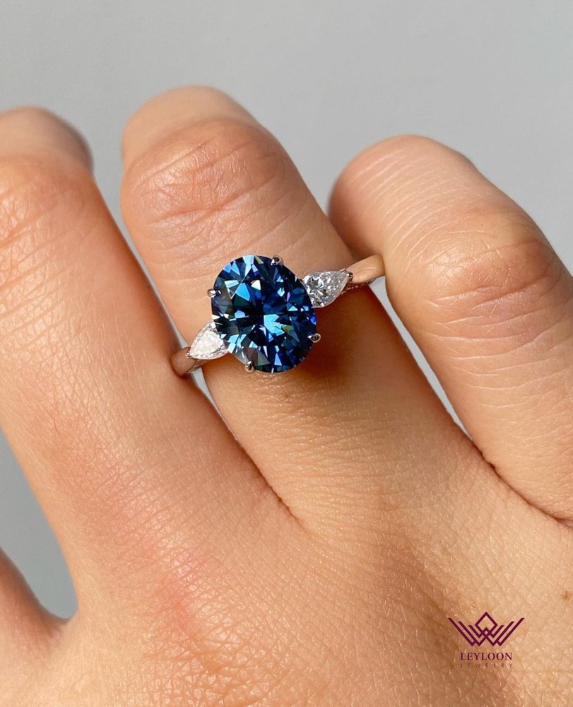 Oval Blue Moissanite Three Stone Hidden Halo Ring in 18K Gold with Filigree Milgrain Detail
