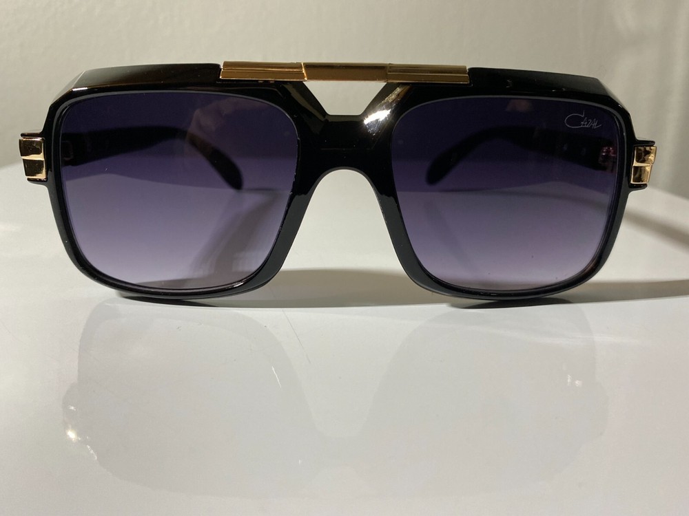 Vintage style men's sunglasses with black frame and purple tinted lenses