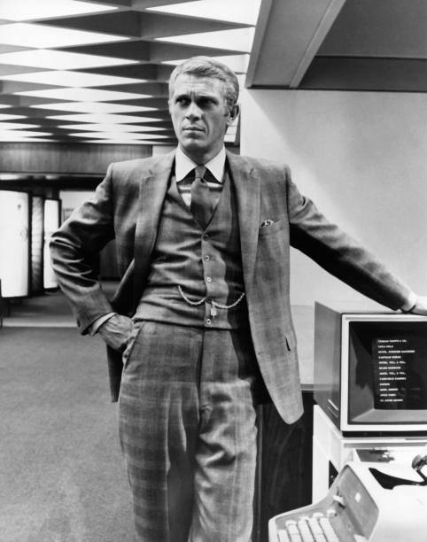 Steve McQueen stands next to a vintage computer monitor dressed in- Old Photo