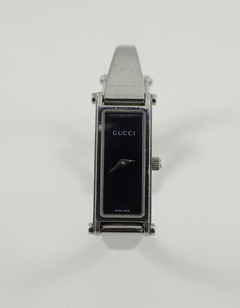 GUCCI women's 1500L analog quartz bangle watch with black dial and silver stainless steel