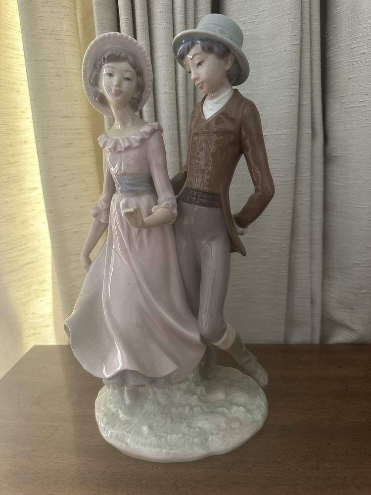 NAO By Lladro figurine boy with girl ( with chips)