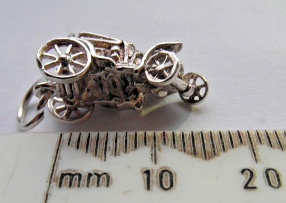 silver charm of a vintage car with moveable front wheels for a charm bracelet